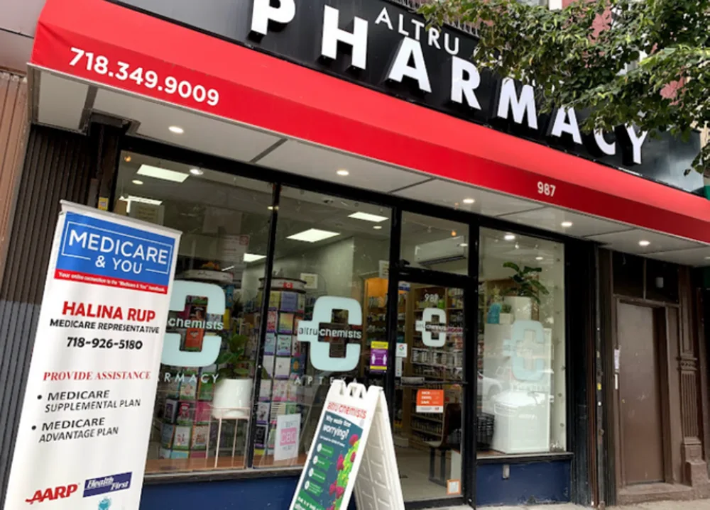 Altru Chemists storefront with its red awning on Manhattan Avenue